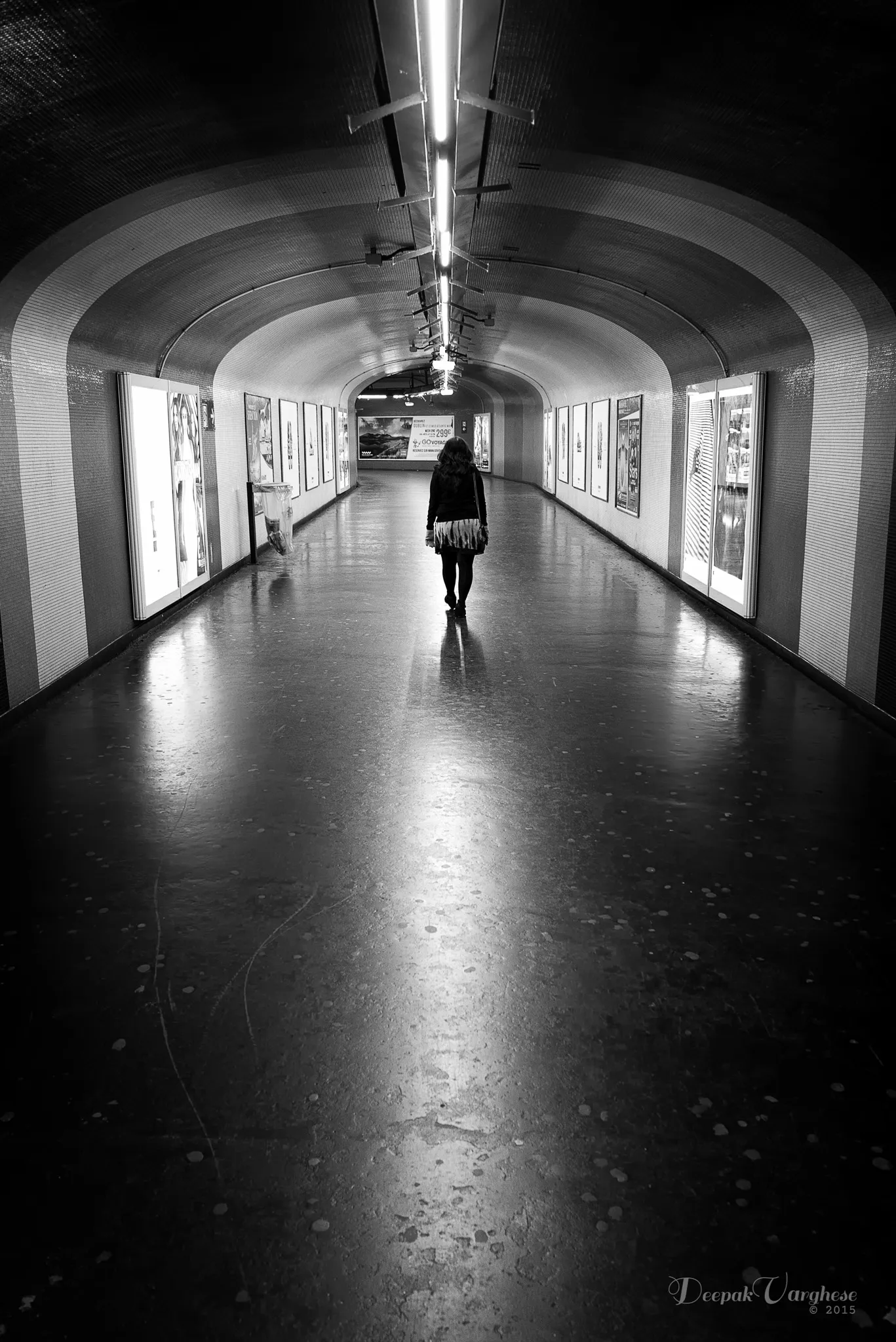 Woman walking in tunnel B&W